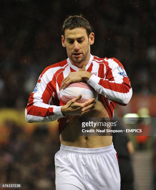 Stoke City's Rory Delap dries the ball with his shirt before launching one of his trademark throw ins
