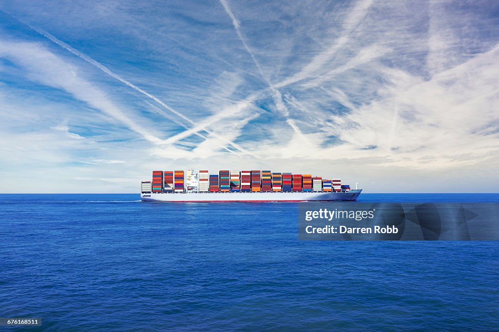Cargo Ship Transporting Containers Across The Sea High-Res Stock Photo ...