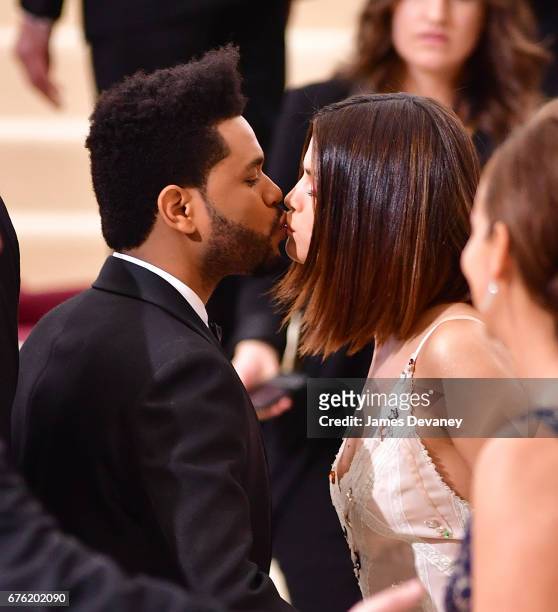 The Weeknd and Selena Gomez kiss at the 'Rei Kawakubo/Comme des Garcons: Art Of The In-Between' Costume Institute Gala at Metropolitan Museum of Art...
