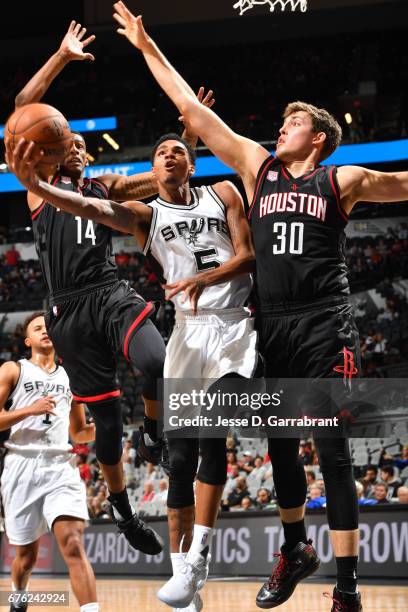 Dejounte Murray of the San Antonio Spurs drives to the basket against Kyle Wiltjer of the Houston Rockets during Game One of the Western Conference...