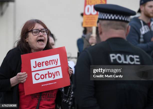 Jeremy Corbyn supporter holds up a sign as Britain's Prime Minister Theresa May makes a campaign stop on May 2, 2017 in Bristol, England. The Prime...