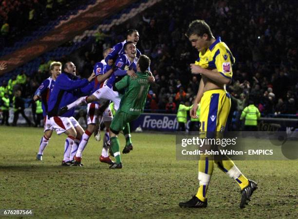 Carlisle United's goalkeeper Adam Collin is congratulated on saving the final penalty by Leeds United's Shane Lowry to win them the game