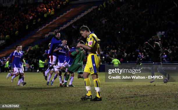 Carlisle United's goalkeeper Adam Collin is congratulated on saving the final penalty by Leeds United's Shane Lowry to win them the game as fans...