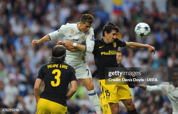 Cristiano Ronaldo of Real Madrid CF beats Stefan Savic of Club Atletico de Madrid to score his team's opening goal in the UEFA Champions League Semi...