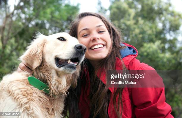 mädchen den hund streicheln - pet adoption stock-fotos und bilder