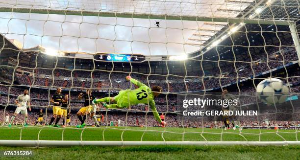 Real Madrid's Portuguese forward Cristiano Ronaldo scores past Atletico Madrid's Slovenian goalkeeper Jan Oblak during the UEFA Champions League...