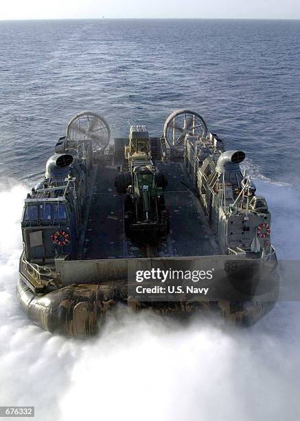 Landing Craft Air Cushioned transport leaves the well deck of the USS Bataan December 5, 2001 while at sea. The LCAC is heading for a beach in...