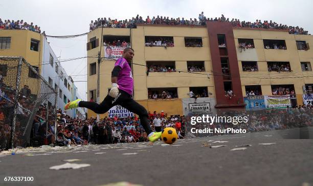 Goalkeeper shot the ball during a soccer street game in Lima, Peru May 1 de 2017. For 64 years every May 1st. Is celebration the Mundialito de El...