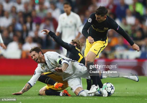 Sergio Ramos of Real Madrid is challenged by Antoine Griezmann and Lucas Hernandez of Atletico Madrid during the UEFA Champions League semi final...