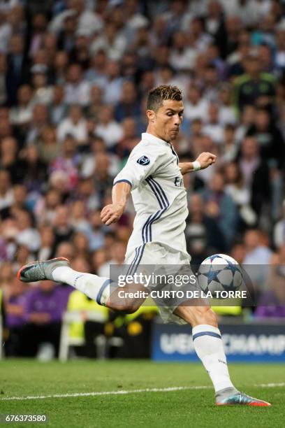 Real Madrid's Portuguese forward Cristiano Ronaldo kicks to score his second goal during the UEFA Champions League semifinal first leg football match...