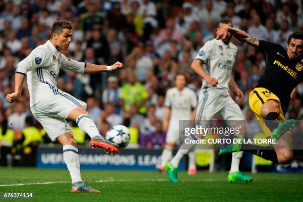 Real Madrid's Portuguese forward Cristiano Ronaldo kicks to score his second goal during the UEFA Champions League semifinal first leg football match...