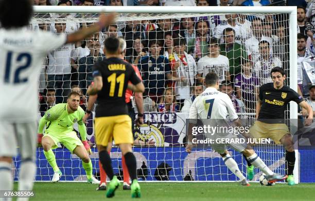 Real Madrid's Portuguese forward Cristiano Ronaldo kicks to score his third goal during the UEFA Champions League semifinal first leg football match...