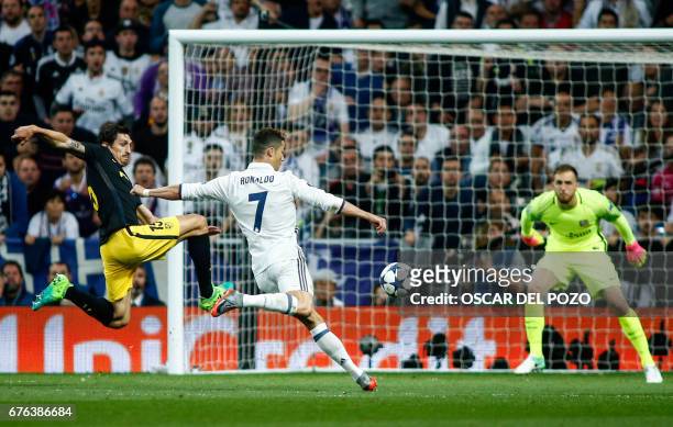 Real Madrid's Portuguese forward Cristiano Ronaldo shoots to score a goal beside Atletico Madrid's Montenegrin defender Stefan Savic during the UEFA...