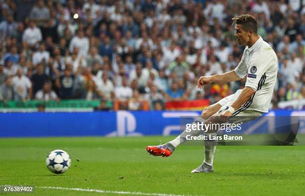 Cristiano Ronaldo of Real Madrid scores their third goal and completes his hat trick during the UEFA Champions League semi final first leg match...