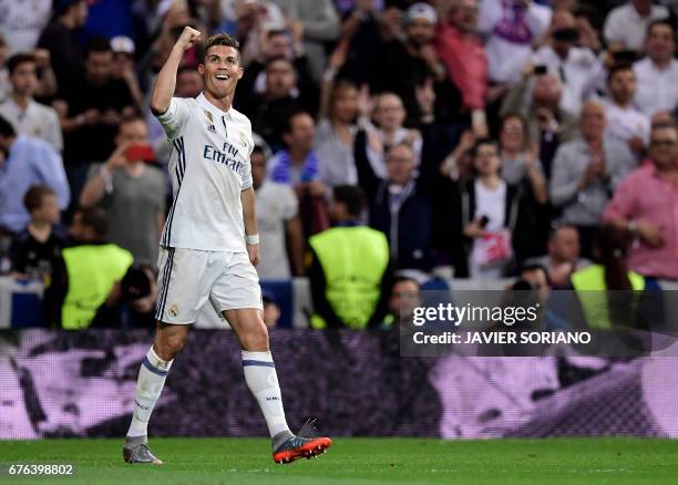 Real Madrid's Portuguese forward Cristiano Ronaldo celebrates his third goal during the UEFA Champions League semifinal first leg football match Real...