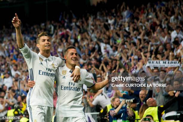 Real Madrid's Portuguese forward Cristiano Ronaldo and Real Madrid's midfielder Lucas Vazquez celebrate their 3-0 victory over Atletico at the end of...