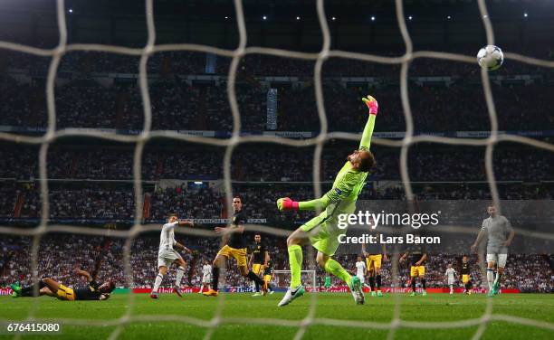 Cristiano Ronaldo of Real Madrid scores their second goal past goalkeeper Jan Oblak of Atletico Madrid during the UEFA Champions League semi final...