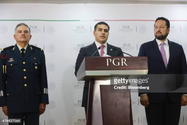 Omar Hamid Garcia Harfuch, director of the criminal investigation agency , center, speaks while Alonso Israel Lira Salas, director of the assistant...