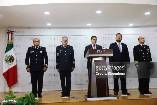 Omar Hamid Garcia Harfuch, director of the criminal investigation agency , center, Alonso Israel Lira Salas, director of the assistant attorney...