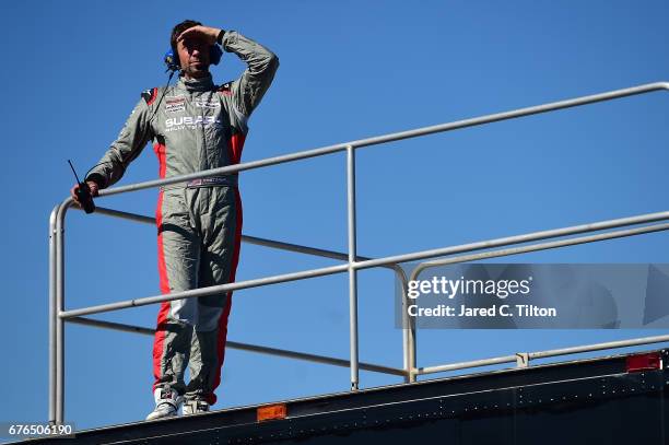 Travis Pastrana, driver of the Niece Motorsports Chevrolet, stands on top of his team hauler during the NASCAR Camping World Truck Series test...