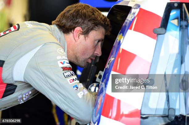 Travis Pastrana, driver of the Niece Motorsports Chevrolet, speaks with T.J. Bell in the garage area during the NASCAR Camping World Truck Series...