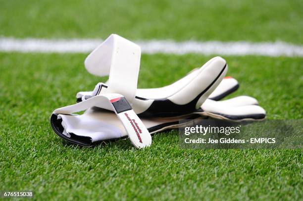 Detail of goalkeeper's gloves laying on the pitch