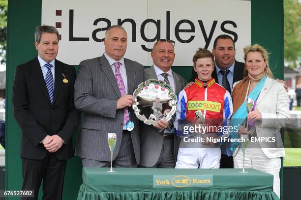 Jockey David Probert and trainer Miss Gay Kelleway receive the trophy after winning the Langleys Solicitors E.B.F. Marygate Fillies' Stakes with...