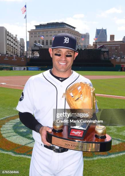 Ian Kinsler of the Detroit Tigers poses for a photo with his 2016 Rawlings Gold Glove Award presented to him prior to the game against the Minnesota...