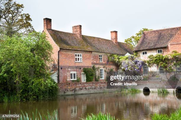 chilly springtime sun on famous beauty spot and tourist destination on river stour in essex england - idyllic cottage stock pictures, royalty-free photos & images