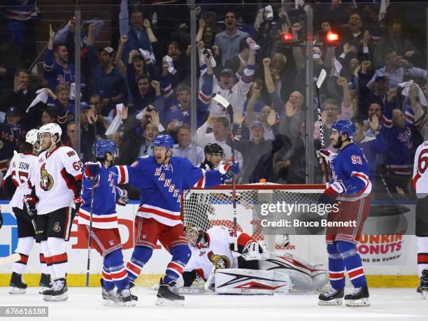 Michael Grabner of the New York Rangers celebrates his first-period goal against Craig Anderson of the Ottawa Senators and is joined by Mats...