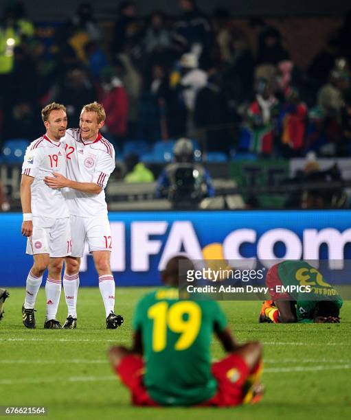 Cameroon's Stephane M'bia Etoundi and Vincent Aboubakar dejected as Denmark's Thomas Kahlenberg and Dennis Rommedahl celebrate victory after the...
