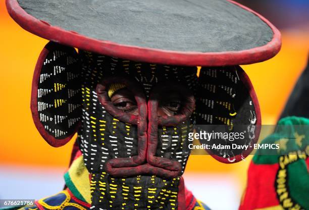 Cameroon fan wearing a mask in the stands prior to kick off