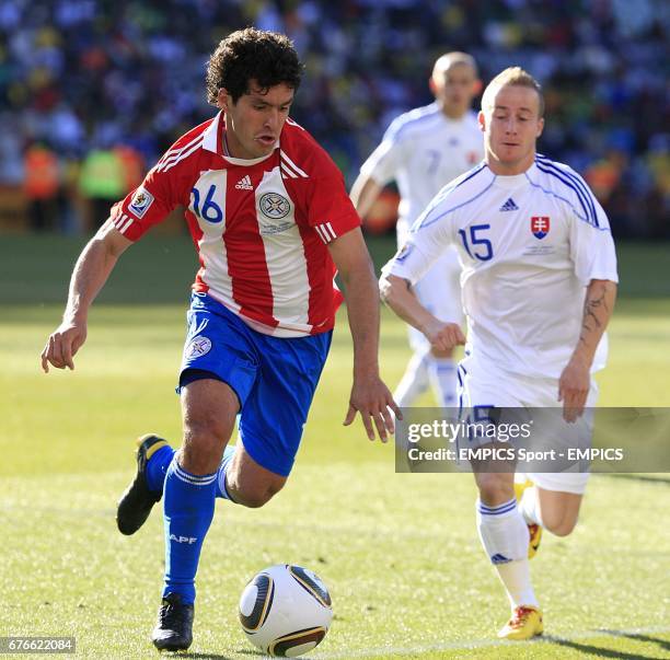 Paraguay's Cristian Riveros and Slovakia's Miroslav Stoch battle for the ball
