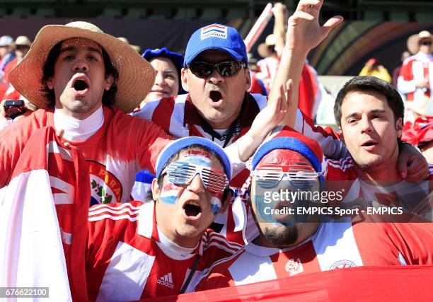 Paraguay fans cheer on their side in the stands