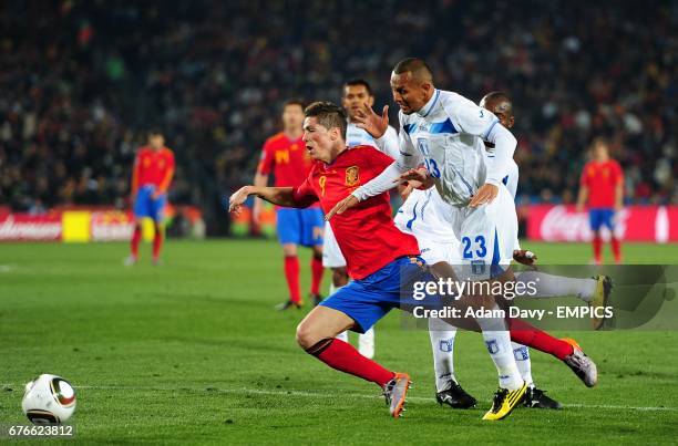 Spain's Fernando Torres goes down in the penalty area under a tackle by Honduras's Sergio Mendoza