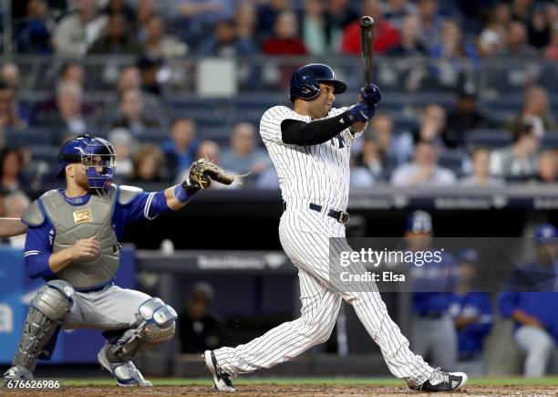 Aaron Hicks of the New York Yankees hits a two run home run in the second inning as Russell Martin of the Toronto Blue Jays defends on May 2, 2017 at...