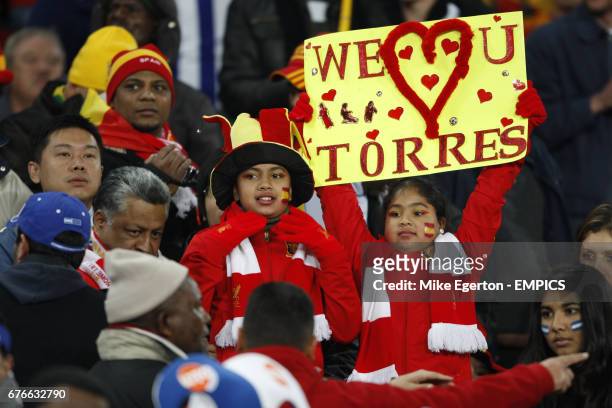 Spain fans hold a 'We love u Torres' sign in the stands