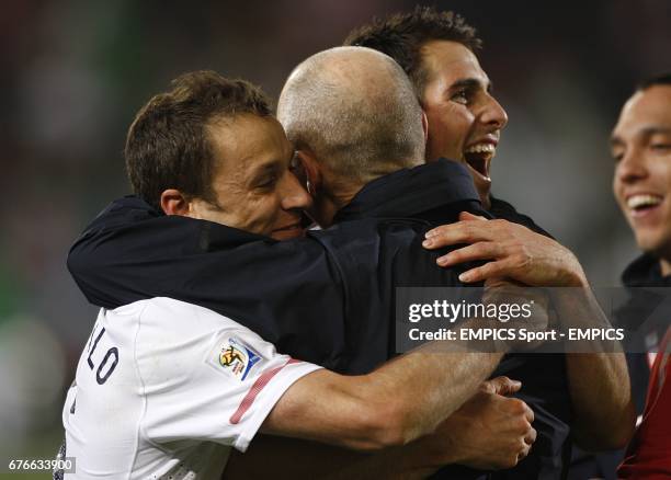 S Steve Cherundolo and Carlos Bocanegra celebrate with manager Bob Bradley after the final whistle