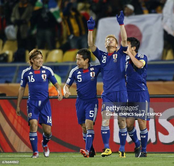 Japan's Keisuke Honda celebrates with team mates Makoto Hasebe , Yuto Nagatomo and Yoshito Okubo after he scores the opening goal of the game