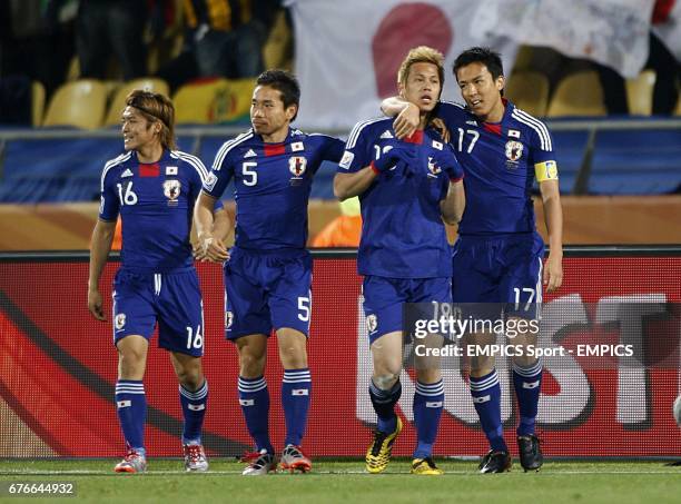 Japan's Keisuke Honda celebrates with team mates Makoto Hasebe , Yuto Nagatomo and Yoshito Okubo after he scores the opening goal of the game