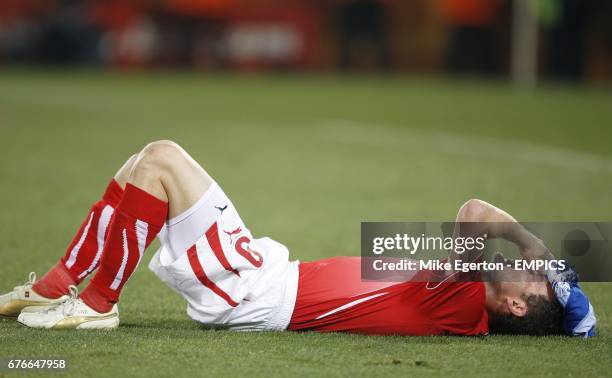 Switzerland's Alexander Frei lies dejected on the ground after his ream were knocked out of the World Cup.