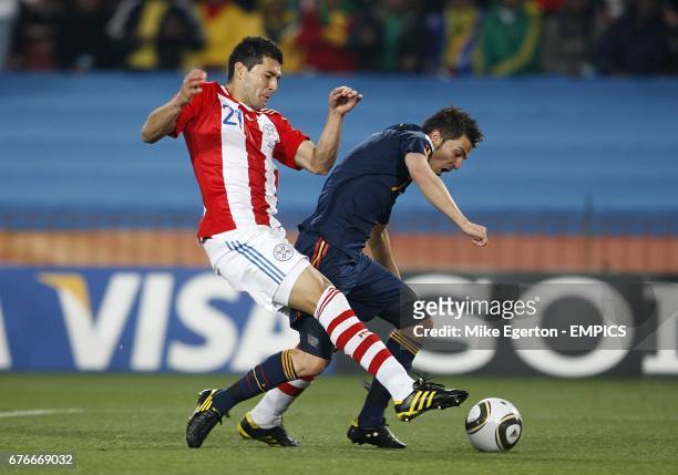 Paraguay's Antolin Alcaraz fouls Spain's David Villa in the penalty area, a foul for which he was booked.