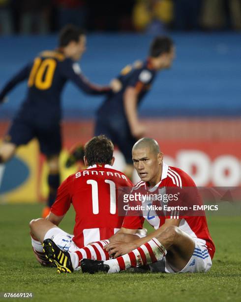 Paraguay's Dario Veron and Jonathan Santana appear dejected after Spain's David Villa scored the only goal of the game.