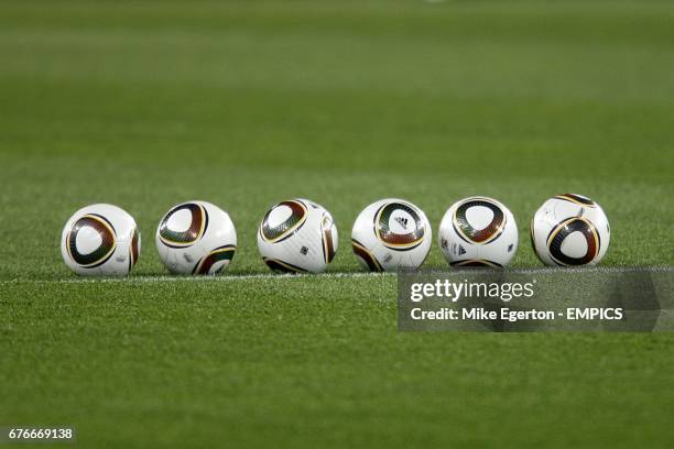 General view of the official World Cup footballs lined up on the pitch.