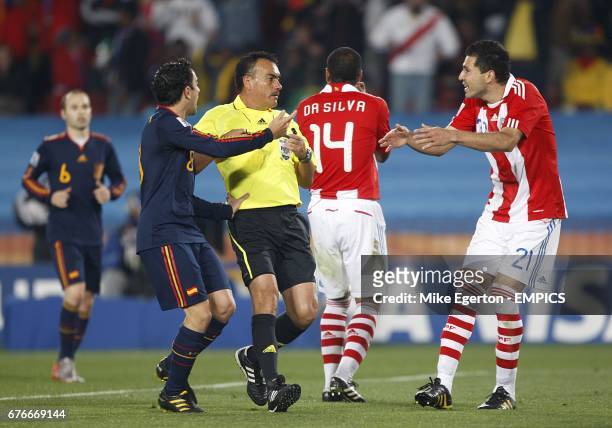 Paraguay's Antolin Alcaraz argues with referee Carlos Batres prior to being booked.