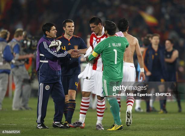 Paraguay's Oscar Cardozo is comforted by his team mates after the final whistle.