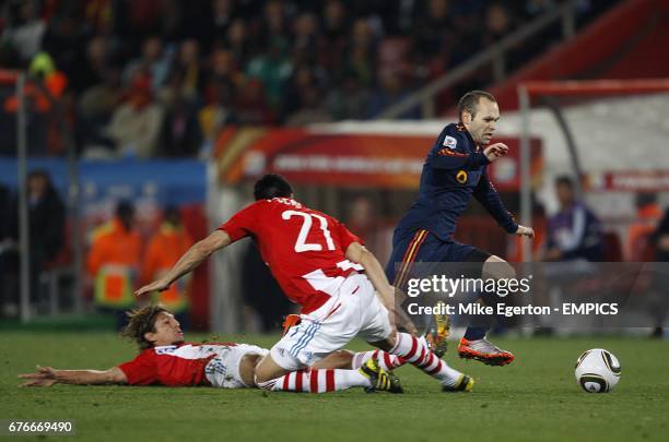 **Alternative Crop** Spain's Andres Iniesta is challenged by Paraguay's Enrique Vera and Antolin Alcaraz .