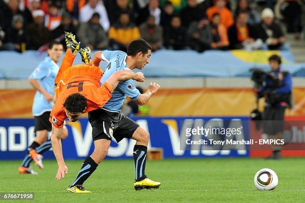 Uruguay's Walter Gargano and Netherlands' Mark Van Bommel battle for the ball