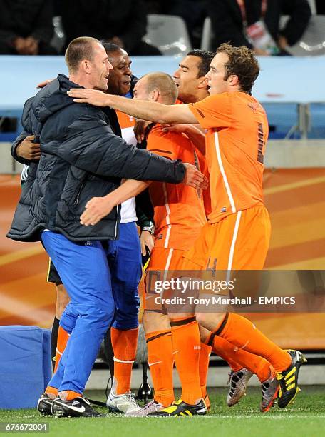 Netherlands' Wesley Sneijder is mobbed by team mates after scoring his sides second goal of the game