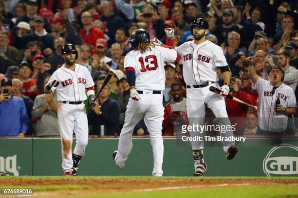 Hanley Ramirez of the Boston Red Sox celebrates with Mitch Moreland after hitting a solo home run during the sixth inning against the Baltimore...